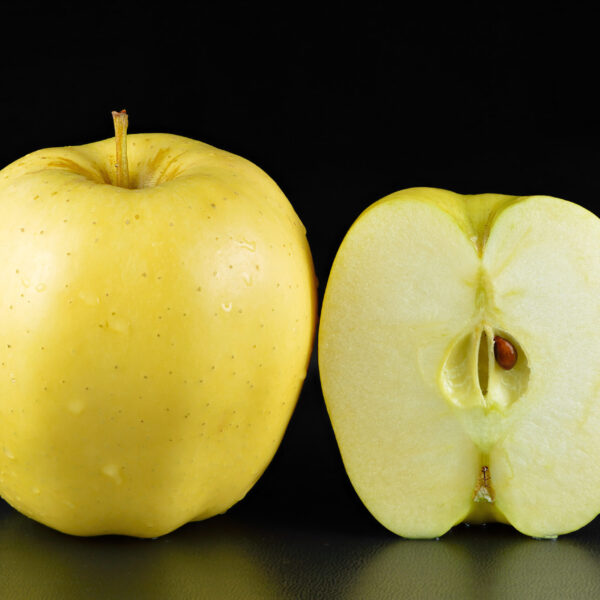 Golden Delicious apple whole and halved